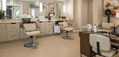 A well-lit salon area with hair styling chairs