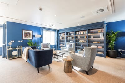 A cozy common area with seating and bookshelves