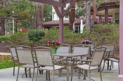 Outdoor dining area with tables and flowers