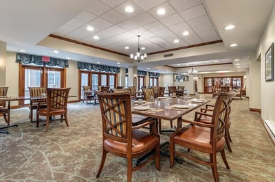 Dining room set up for meals with tables and chairs
