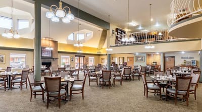 Interior dining room with tables set for residents