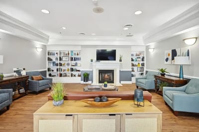 Inviting common area with seating and bookshelves