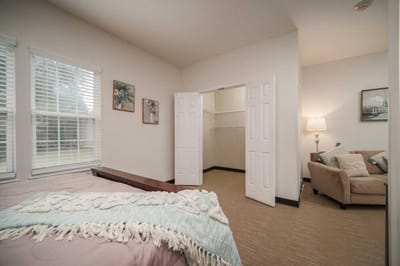 Private resident room with a bed and seating area