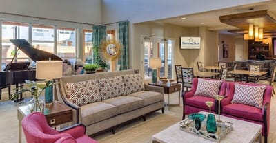 Bright common area with modern furnishings and piano