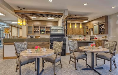 Bright dining area with tables and flowers