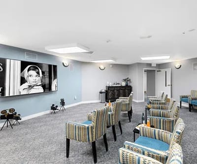 Interior view of a common area with seating and a screen