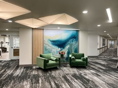 Interior view of a lounge area with green chairs