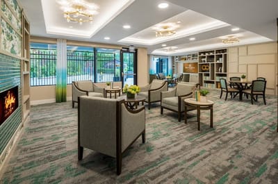 Bright and inviting common area with seating and green accents