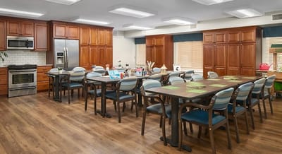 Bright common area with tables and chairs for activities