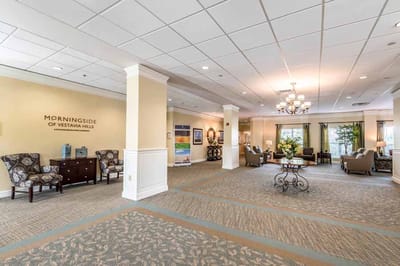 Common area with seating and decor in a senior living facility