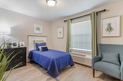 Private resident room with a bed and chair