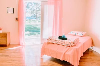 A bright private room with a bed and view of the outdoors