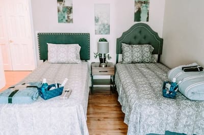 Brightly decorated private resident room with twin beds
