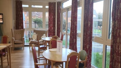 Bright common area with large windows and comfortable seating