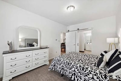 Well-furnished resident room with a bed and dresser