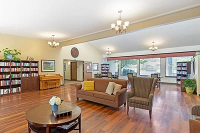 Bright common area with seating and bookshelves
