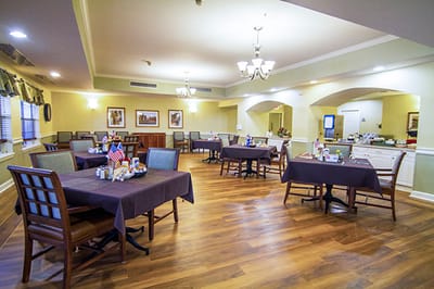 Dining area with tables and chairs set up for meals