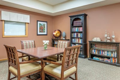 Cozy interior common area with a table and bookshelves