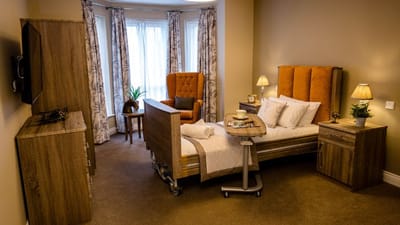 Cozy resident bedroom with a bed and armchair