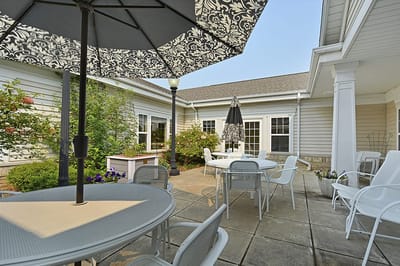 Outdoor seating area with umbrellas and gardens