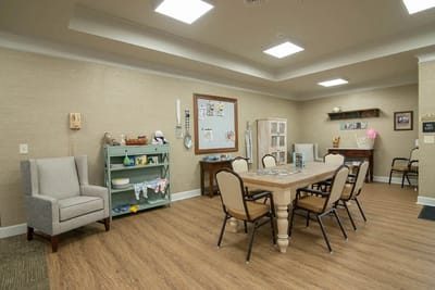 Bright common area with a large table and chairs