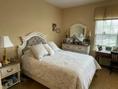 Cozy private resident room with a bed and furnishings