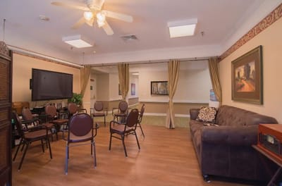 Common area with seating and TV in a bright room