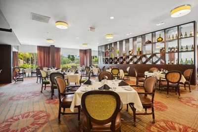 Dining room with elegantly set tables and chairs
