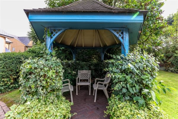 Garden gazebo surrounded by greenery