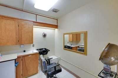 Interior of a hair salon area with basic furnishings