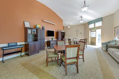 Bright common area with seating and a TV
