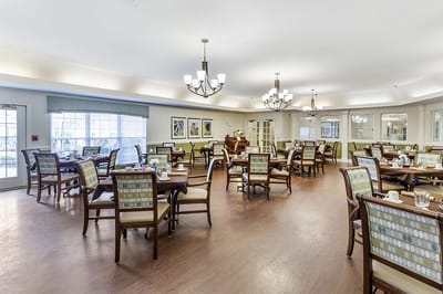 Dining room with tables and chairs set for meals