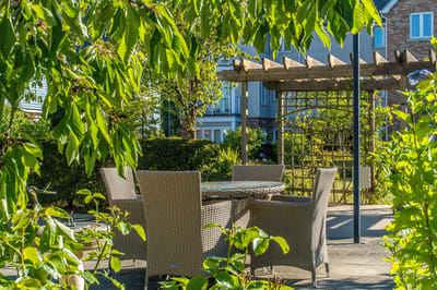 Outdoor seating area surrounded by greenery