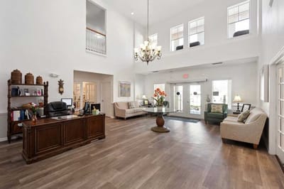 Bright lobby area with seating and a reception desk