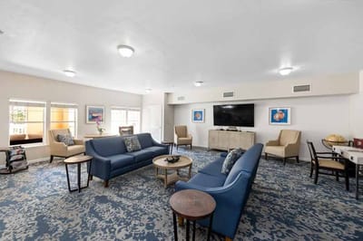 Bright common area with seating and TV