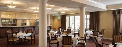 Dining room with elegantly set tables and lighting