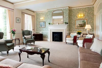 Bright common area with comfortable seating and floral decor