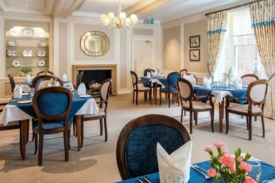Elegant dining room set for a meal with flowers on the table