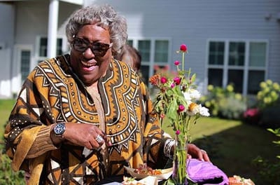 Resident enjoying an outdoor meal and smiling