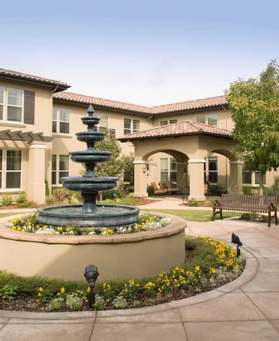 Outdoor courtyard with fountain and flowers