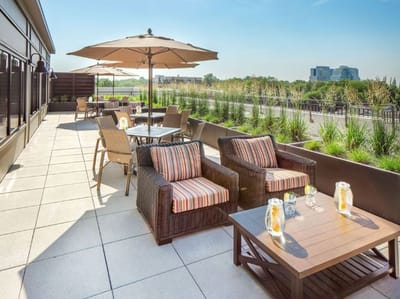 Outdoor patio seating area with umbrellas and plants