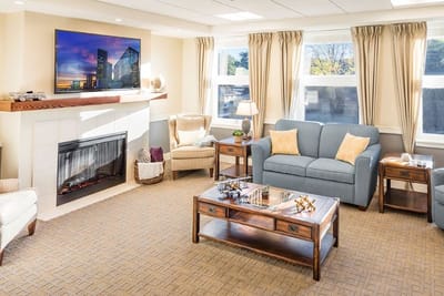 Bright common area with comfortable seating and a fireplace