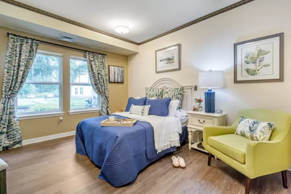 Cozy private resident room with a bed and seating