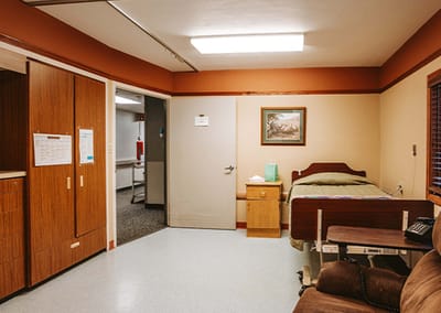 Single private room with a bed and brown furniture