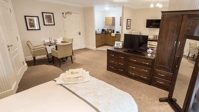 A well-furnished private room in a care facility