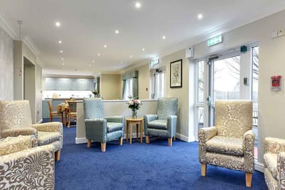 A cozy common area with armchairs and tables