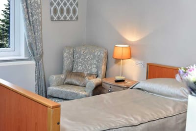 Comfortable private resident room with chair and lamp