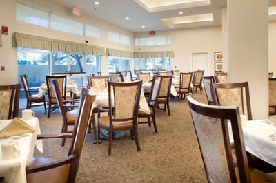 Dining room with tables and chairs set for meals