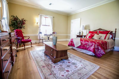 Cozy private bedroom with floral decor and seating area