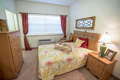Cozy resident room with a neatly made bed and decorations